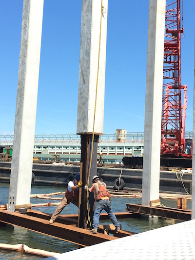 Construction workers installed more-traditional-looking piles for a part of the Pier55 project this past summer. Photo courtesy The Villager.