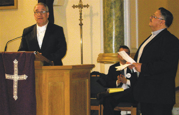 Reverend Getulio Cruz (right), from Monte Sion Christian Church, looked on, as Comptroller Scott Stringer (at podium) gave his remarks at the Manhattan Together gathering. Photo by Lesley Sussman.