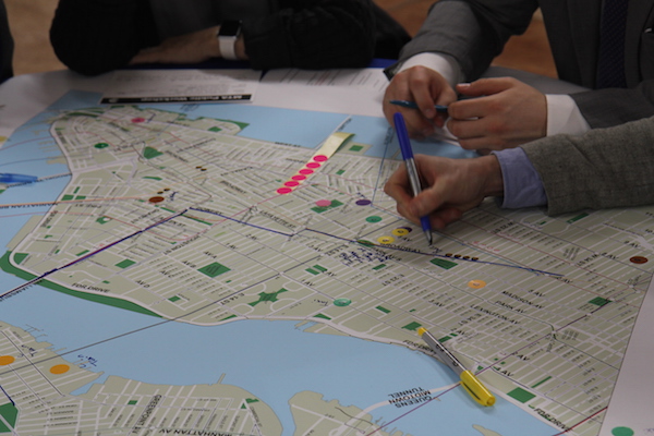 Each table at the workshop drew up routes and options on city maps. Photo by Dennis Lynch.