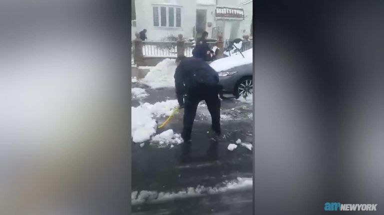 NYPD officers help Queens woman shovel out