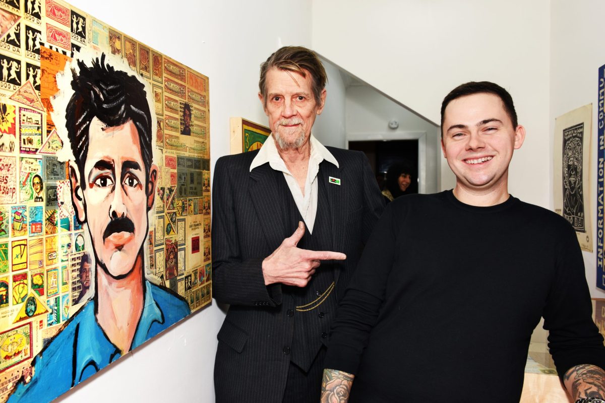 Ed Higgins III, left. Apt. Gallery owner Brendan Brulon, right. Large painting is a Higgins self portrait.