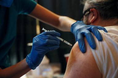 A Metropolitan Transportation Authority (MTA) worker receives the Pfizer COVID-19 vaccination for MTA employees at Vanderbilt Hall at Grand Central Terminal  in the Manhattan borough of New York