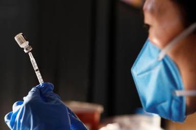 Pharmacist Jeanne Yu prepares the Pfizer COVID-19 vaccination to be administered to Metropolitan Transportation Authority (MTA) workers at Vanderbilt Hall at Grand Central Terminal  in the Manhattan borough of New York