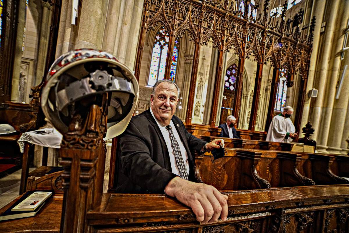 Gary LaBarbera, President of the Building and Construction Trades Council of Greater New York pays his respects by hanging his hat on the pew