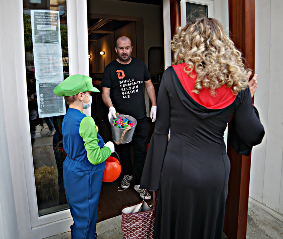 TRICK OR TREAT! Ghosts and goblins of all ages venture across Manhattan