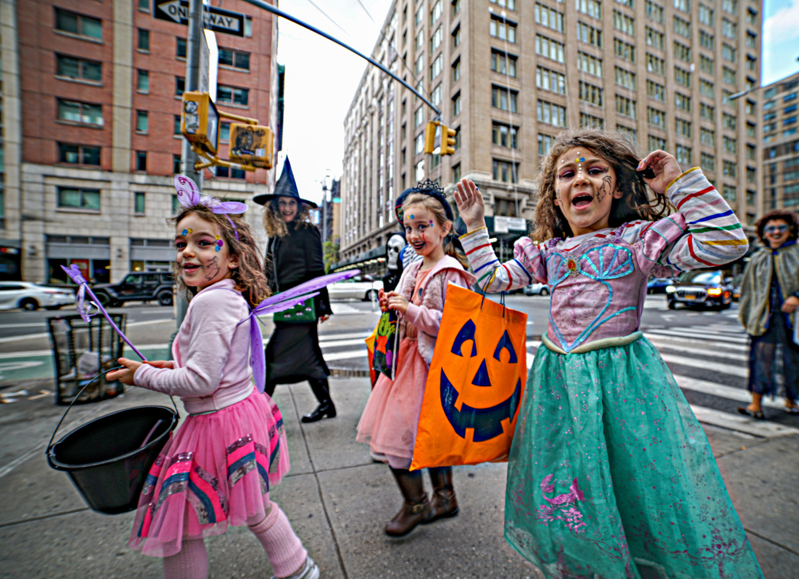 TRICK OR TREAT! Ghosts and goblins of all ages venture across Manhattan