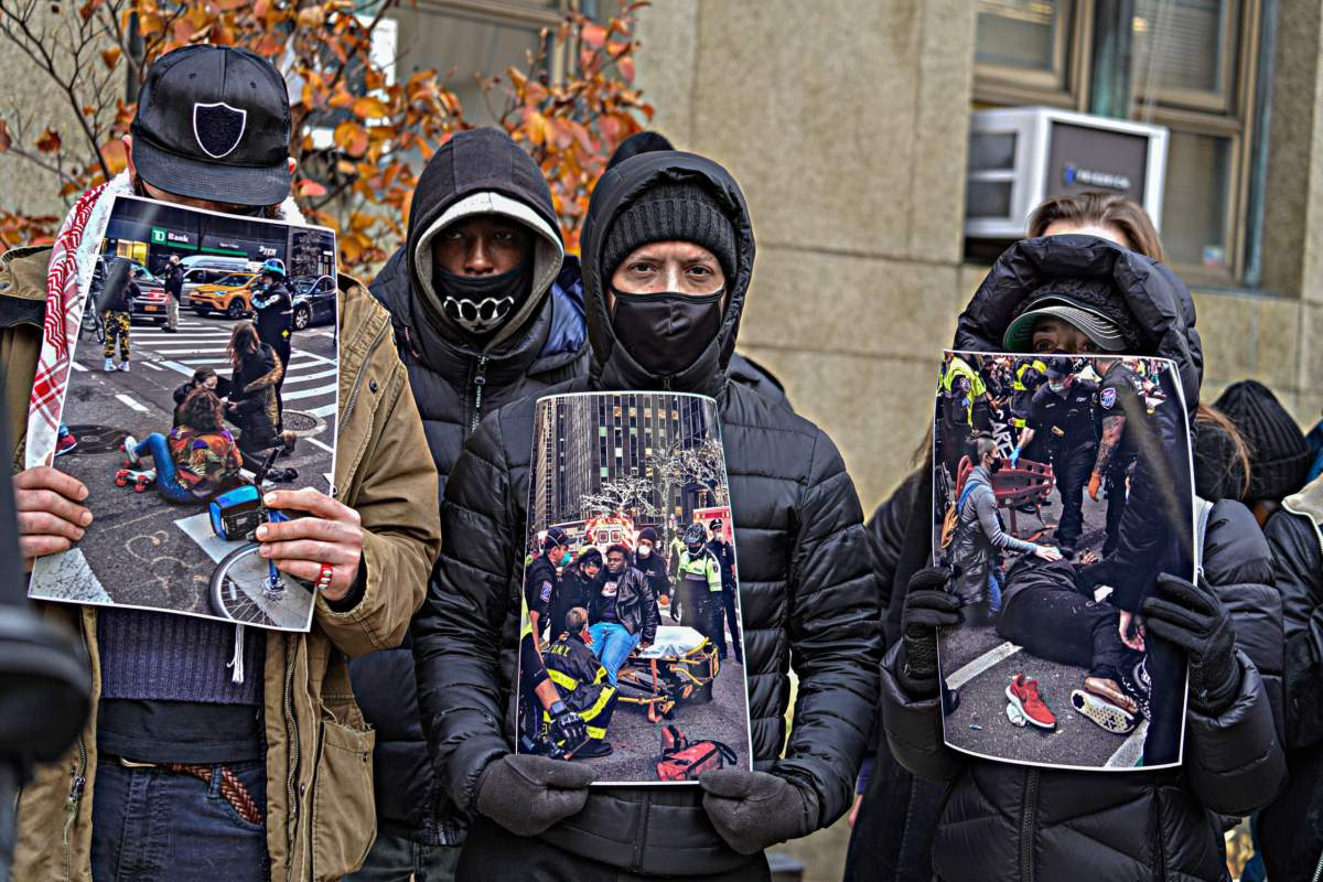 The group held photos of the scene that day