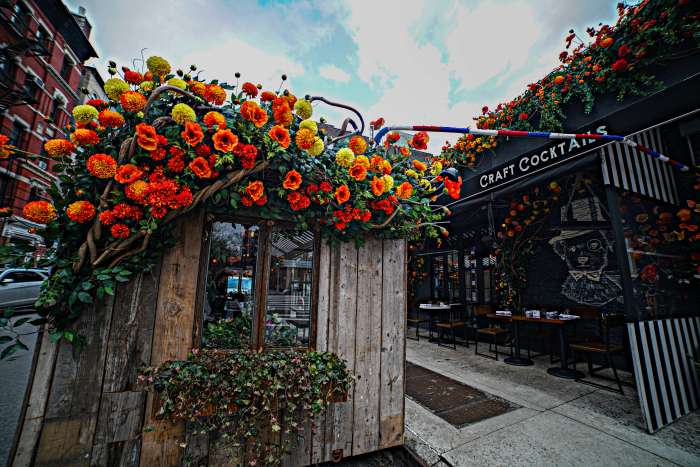 A flower-draped outdoor dining shed at French bistro Loulou