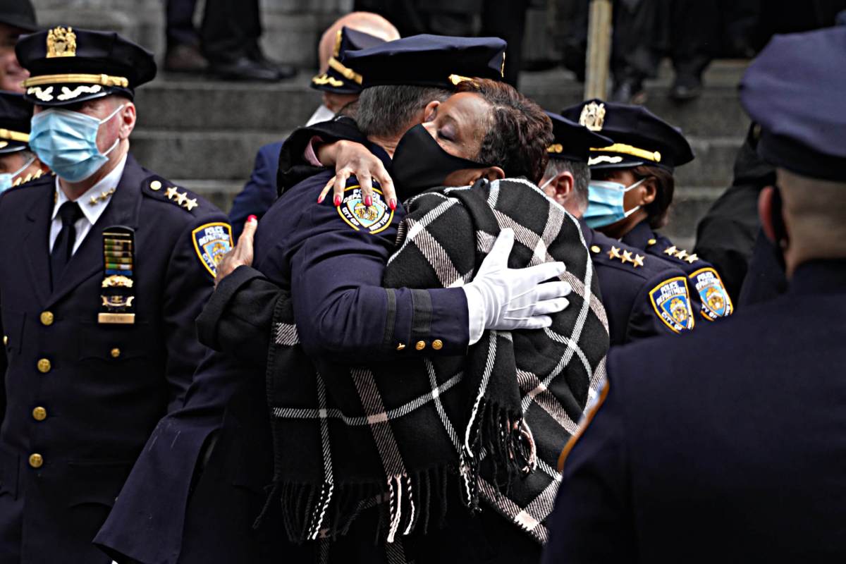 NYC Council Speaker Adrienne Adams embraces an officer