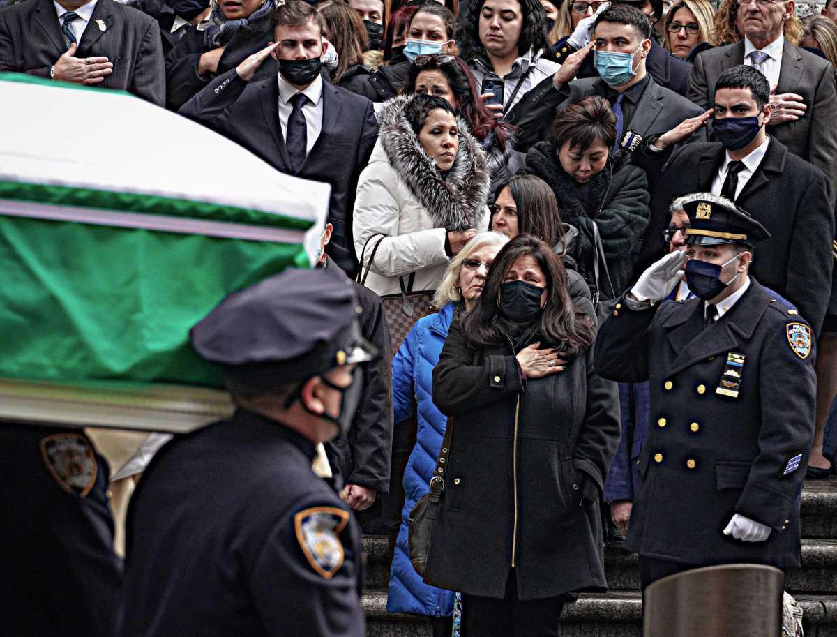 With hands on their hearts and raised salutes, grief gripped attendees as the coffin passed