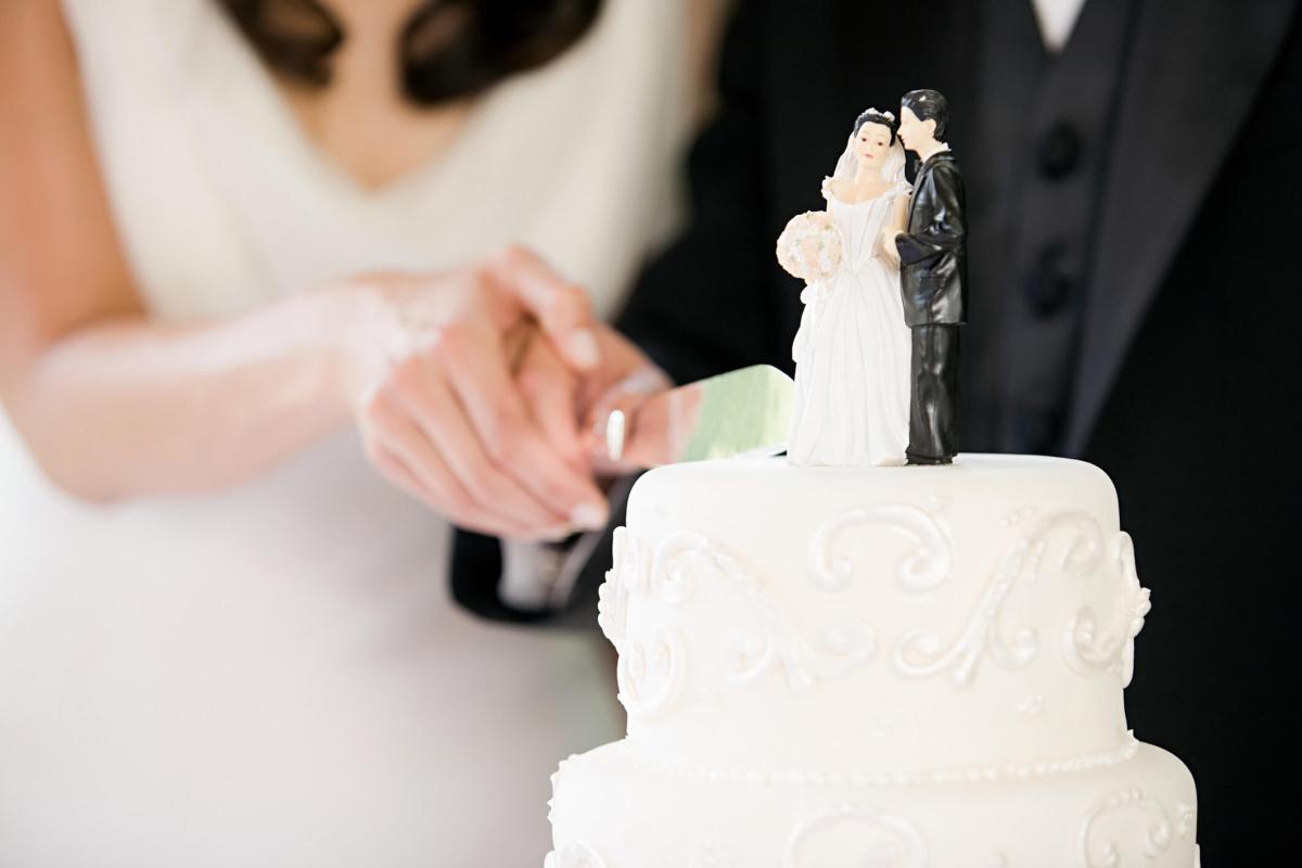 Newlyweds cutting wedding cake