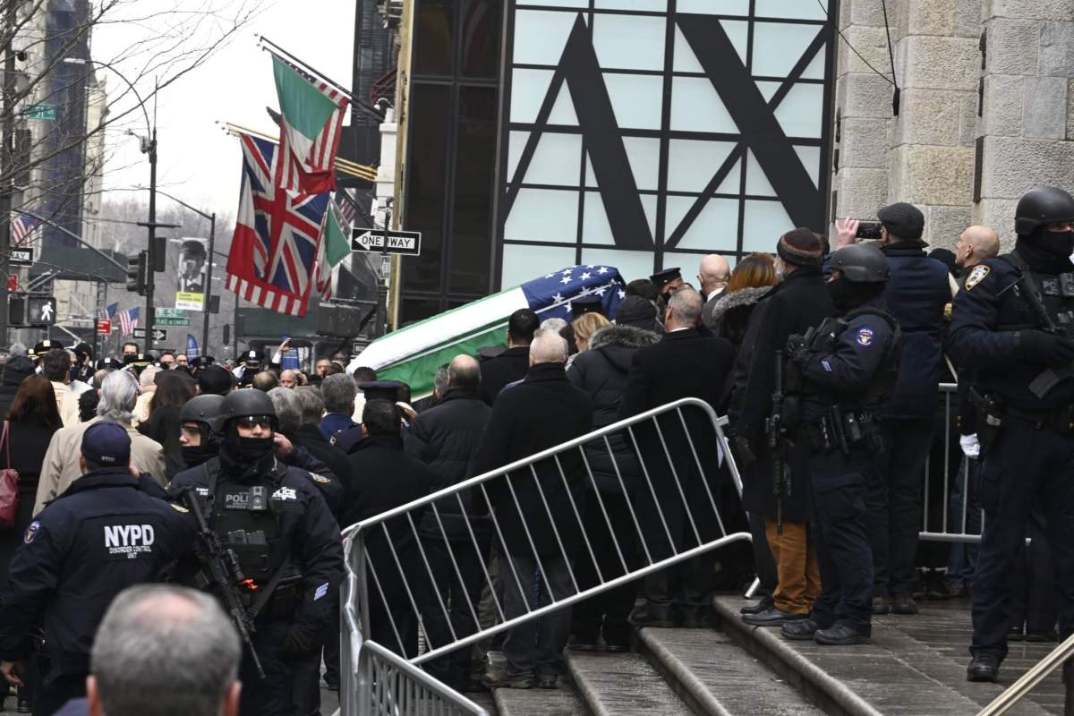 Wilbert Mora's casket is carried down the steps of the cathedral