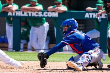 Former-Texas Rangers catcher Jose Trevino fields a ball thrown in the dirt.