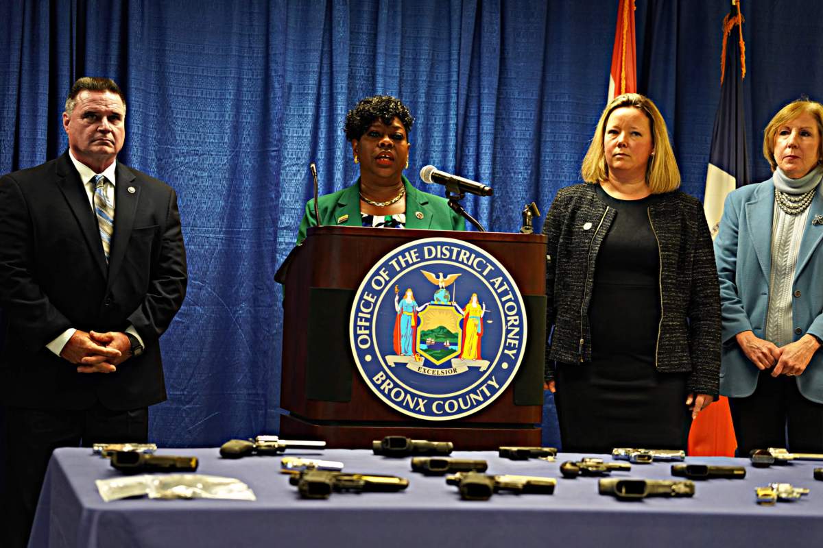 NYPD Chief of Detectives James W. Essig, Bronx District Attorney Darcel D. Clark, and other officials announced the indictment of 20 gang members responsible for a series of violent acts over the past three years.