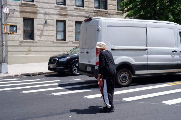 A woman attempts to cross Fort Washington Avenue in Washington Heights