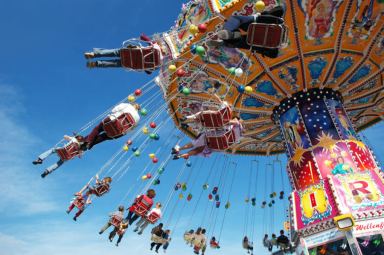 Families at the fair on a swing ride