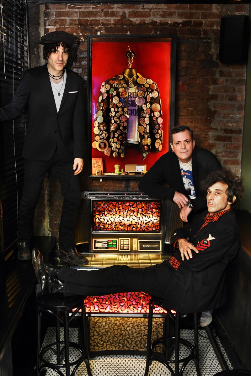 Hangin' by the record machine, L-R: Jesse Malin, Johnny T., Jonathan Toubin. In the showcase is Howie Pyro's jacket, button collection and the "Free Sid Vicious " t-shirt left behind by its namesake