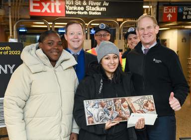 Sasha Salazar, 2022’s one billionth subway rider, poses with MTA leadership and her new subway art