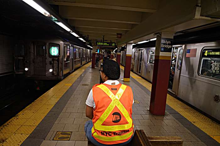 An MTA worker watches over the Brooklyn Bridge City Hall subway station