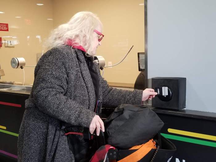 Debra Greif tests a new OMNY reader at the Coney Island customer service center