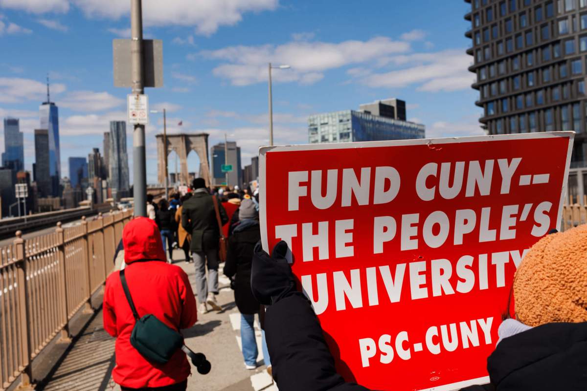 Students, teachers, union members and elected officials march over the Brooklyn Bridge calling for funding for CUNY