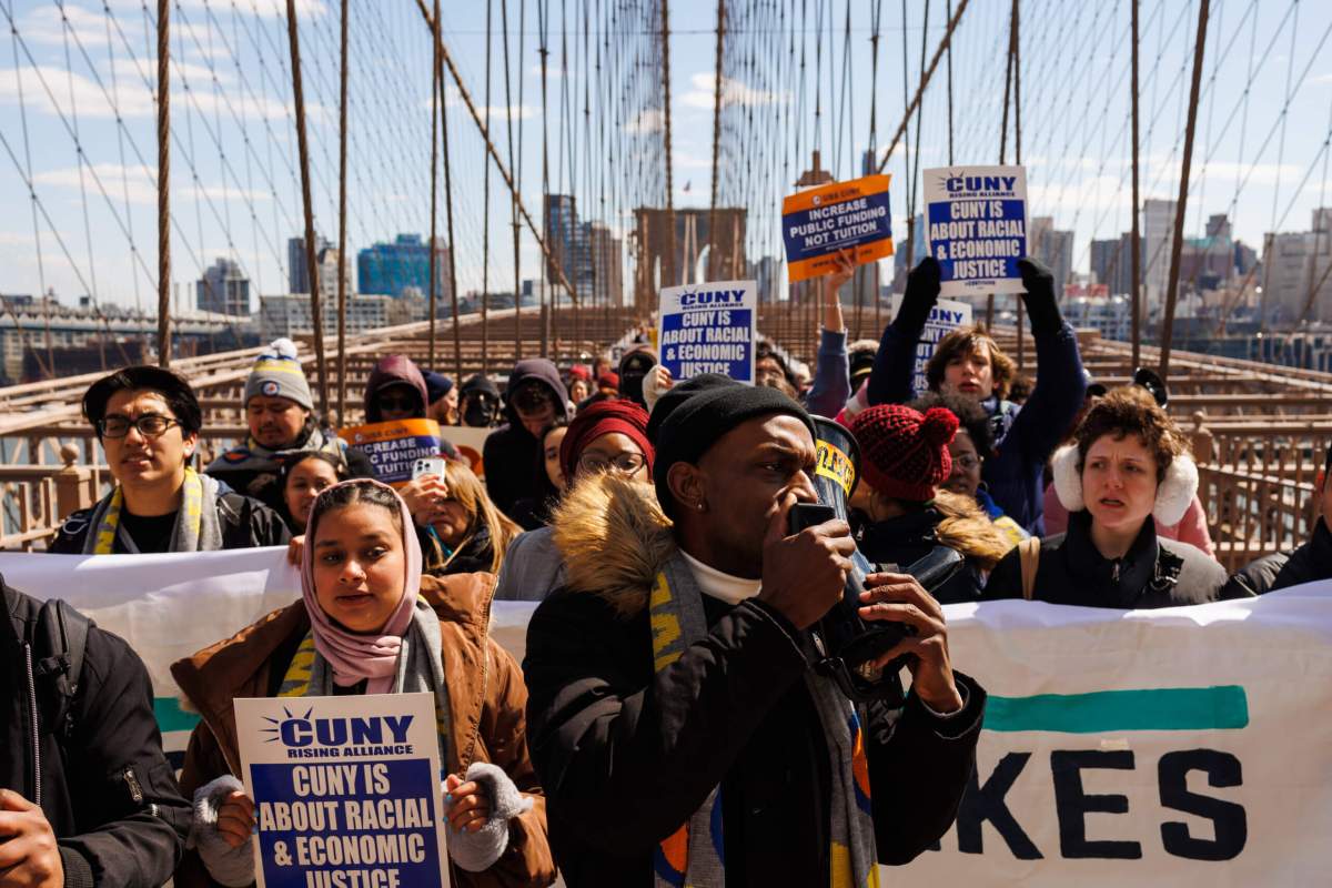Students, teachers, union members and elected officials march over the Brooklyn Bridge during the rally