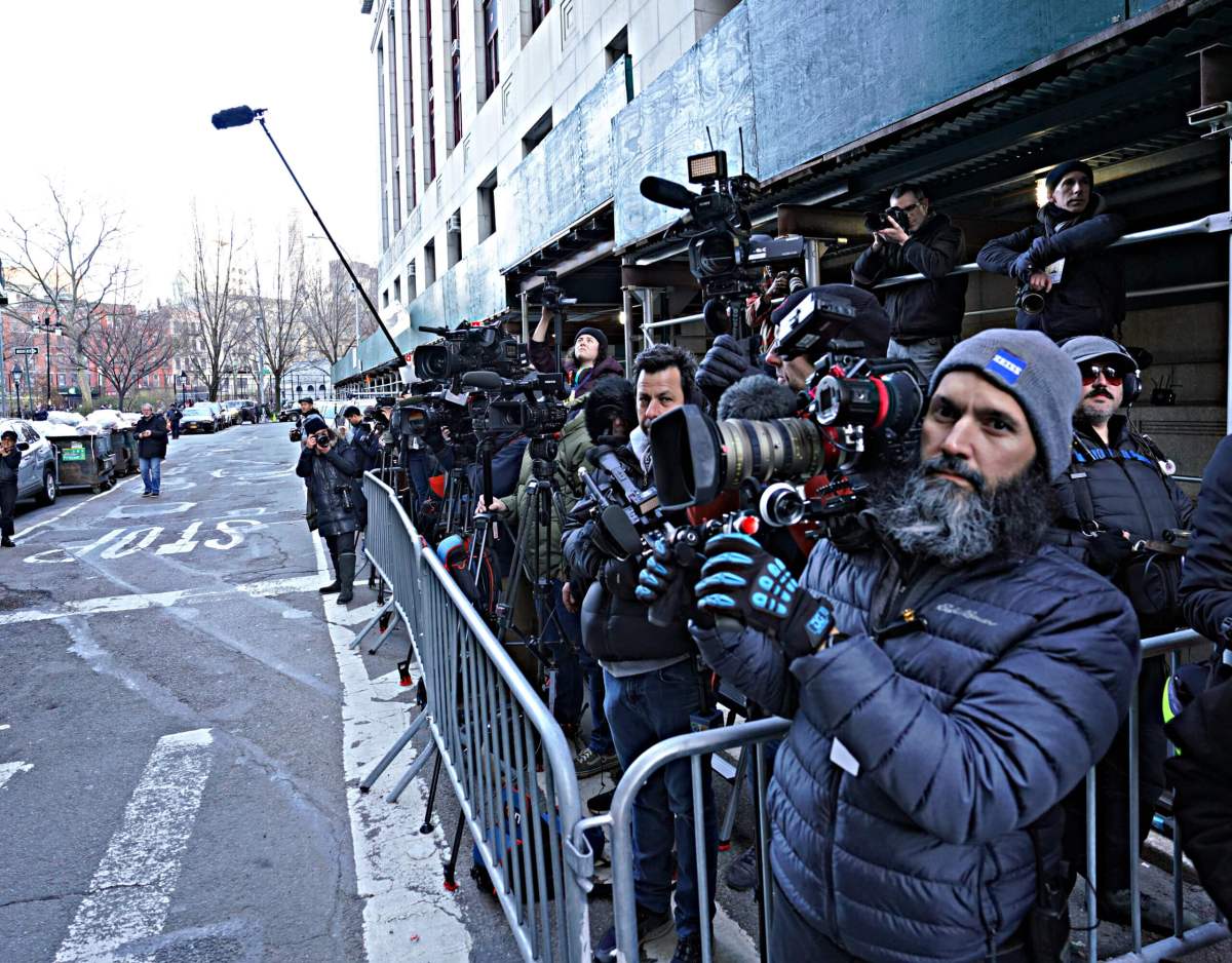 A crush of news reporters waiting outside Manhattan DA Alvin Bragg's office