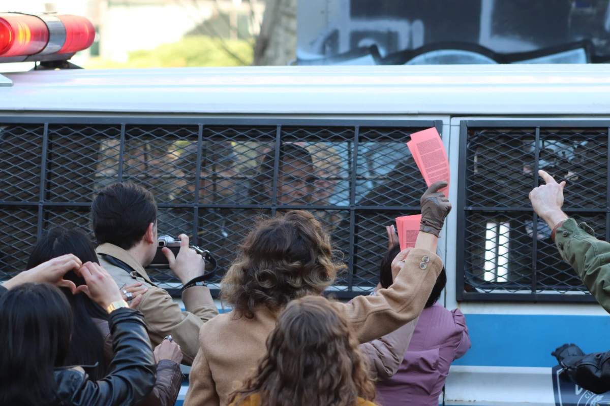 Crowds descend on a police van holding the Joker, on the set of Joker 2, "Joker: Folie à Deux" (Photo by Michael Dorgan)