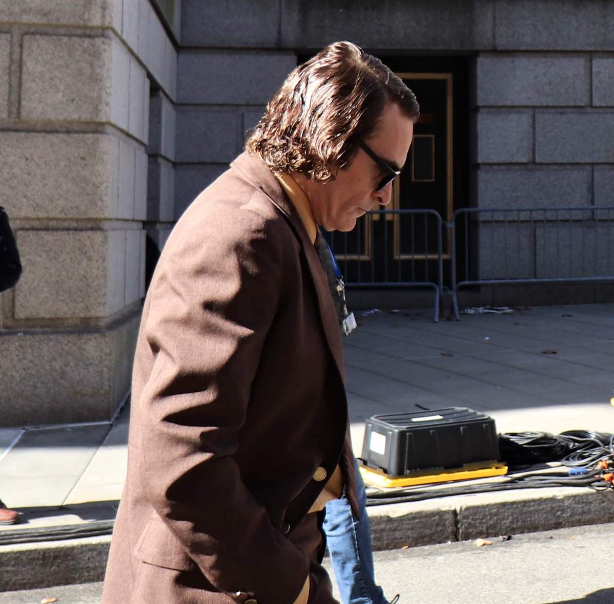 Joaquin Phoenix, who plays Joker, walks to the set of Joker 2, "Joker: Folie à Deux." Phoenix cut an engrossed figure (Photo by Michael Dorgan)