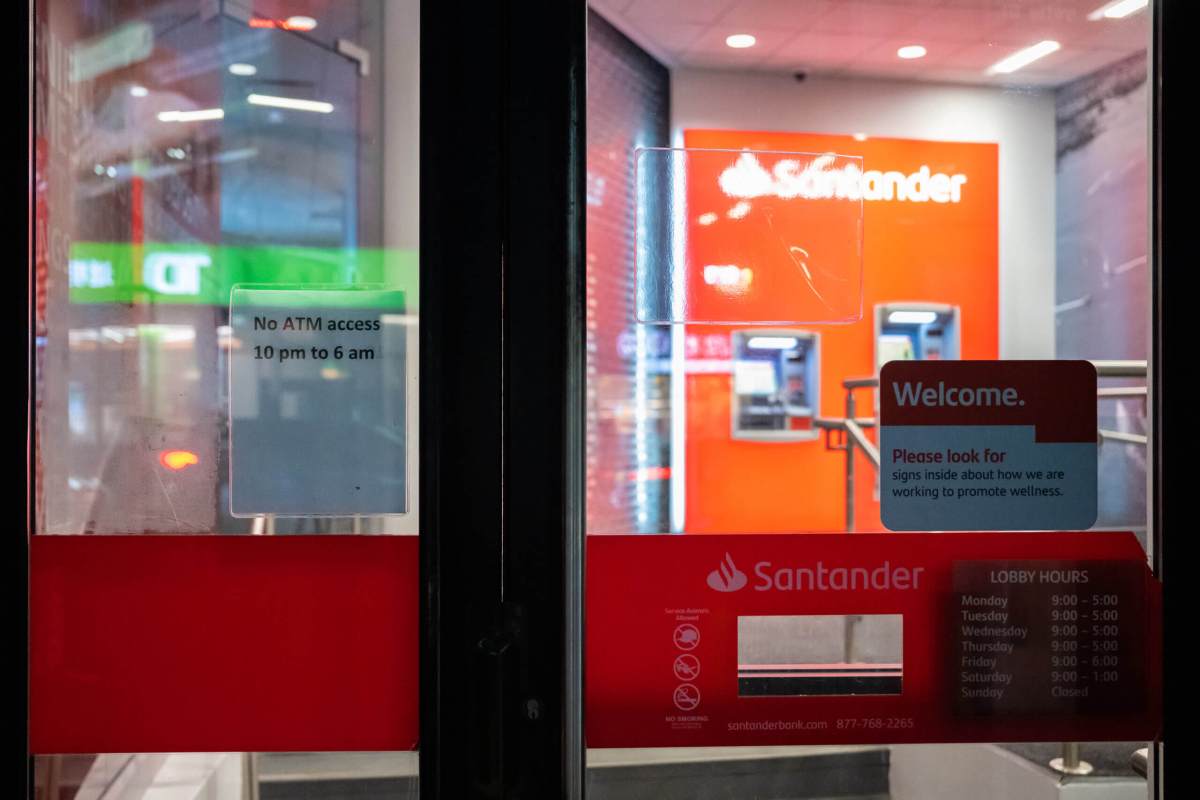 Customer uses ATM at bank in Chinatown