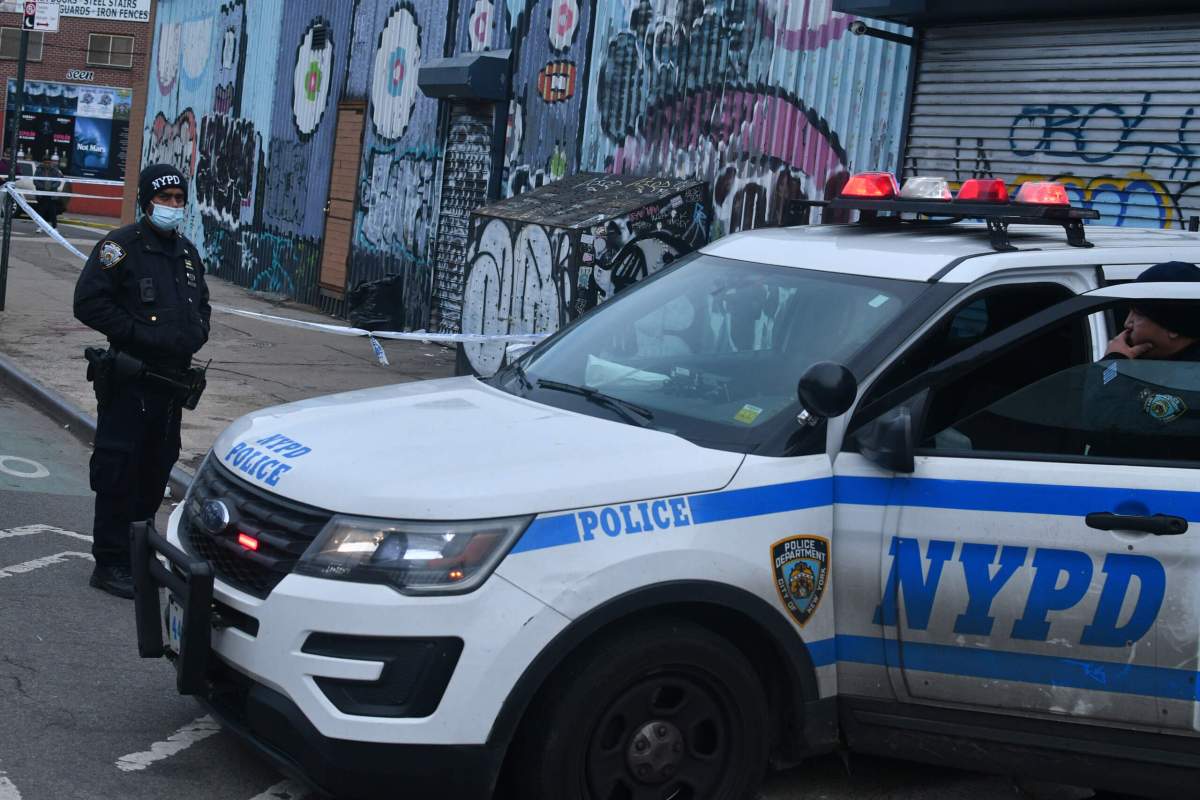 Officers from the 90th Precinct guard a homicide scene