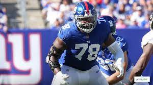 New York Giants tackle Evan Neal #73 walks off the field after