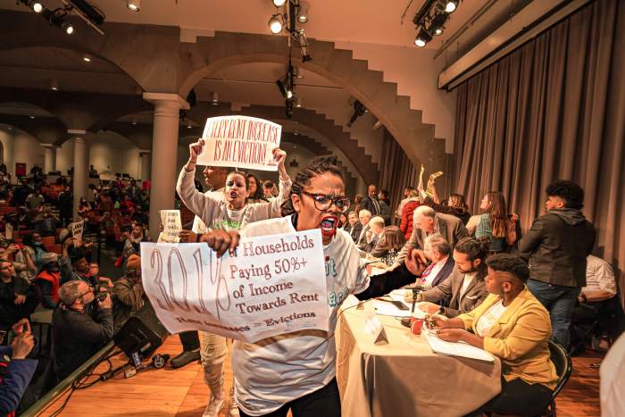 Advocates and councilmembers surrounded board members as they voted on rent increases