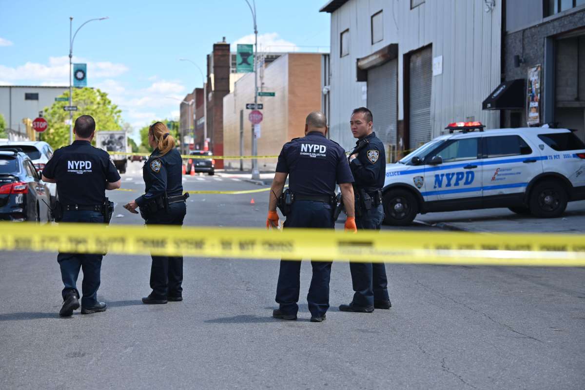 Officers from the 75th Precinct collect evidence