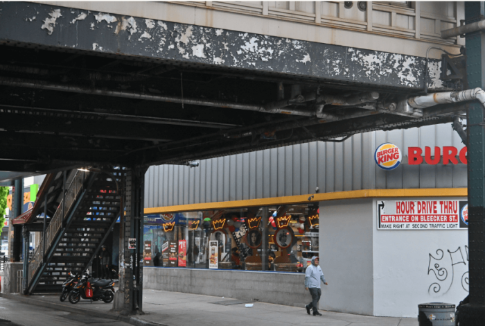 Paint is visibly chipping from the elevated M train station at Knickerbocker Avenue