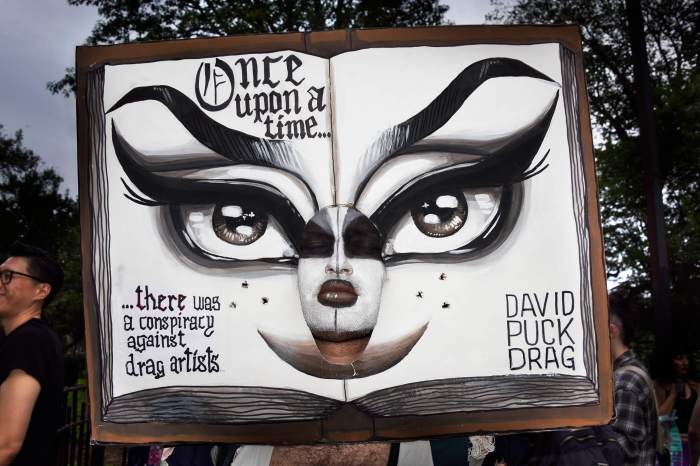 Drag March protester with an open book