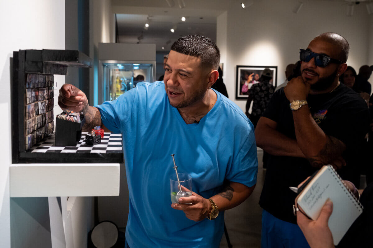 Artist Danny Cortes checks on his miniature artwork titled "Fat Beats" at Sotheby’s.