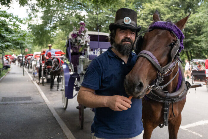 Carriage driver Ahmet Bilici and his horse Chocolate wait for customers