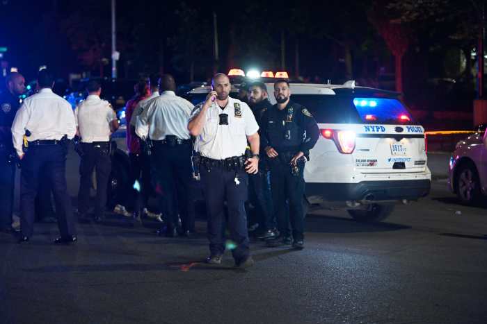 Officers from the 60th Precinct investigate a shooting at the Carey Garden Houses near West 22nd Street and Surf Avenue