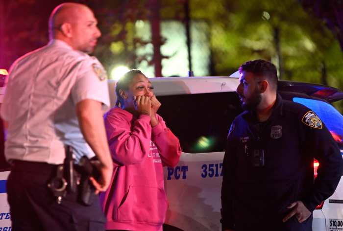 Cops talk to a woman at the scene