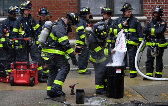 Firefighters work to contain the dangerous battery