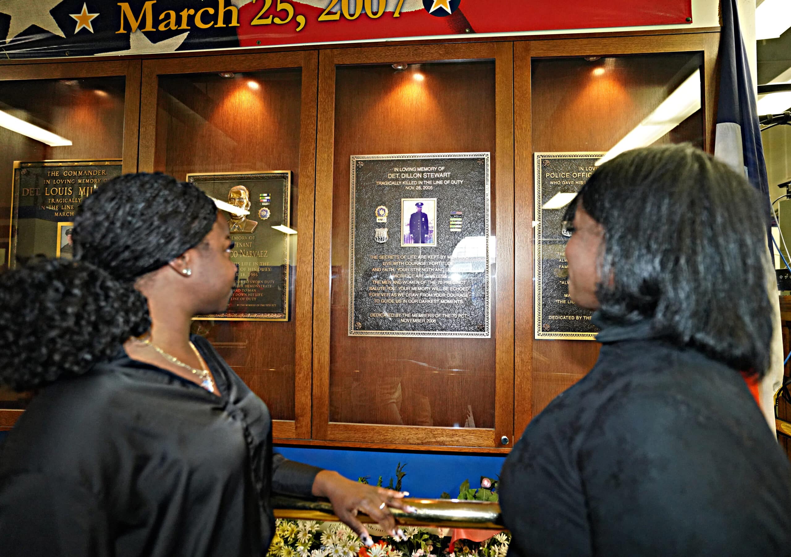 Leslyn Stewart, left, widow of slain New York City Police Detective Dillon  Stewart, holds her daughter Samantha, 2, as she unveils a plaque dedicating  a city playground near Brooklyn's Prospect Park to