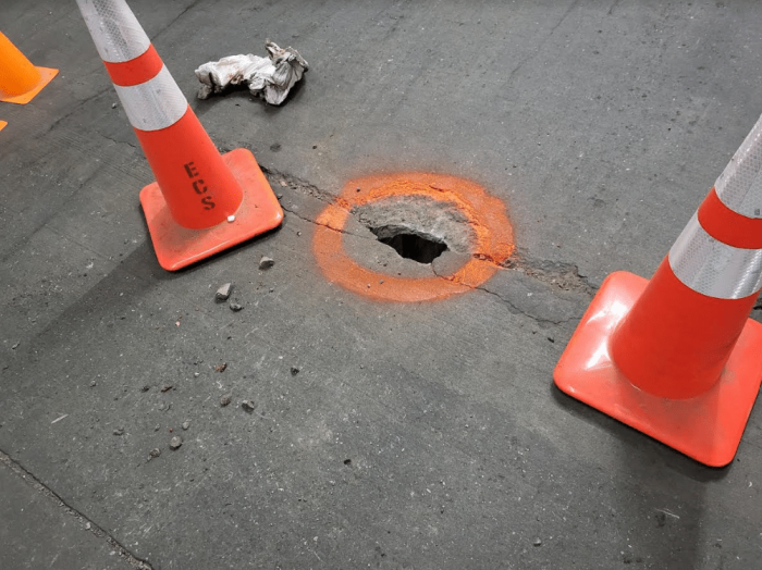 A hole in the roadbed at the Icon parking garage at 51st Street and 10th Avenue, above the Amtrak tracks