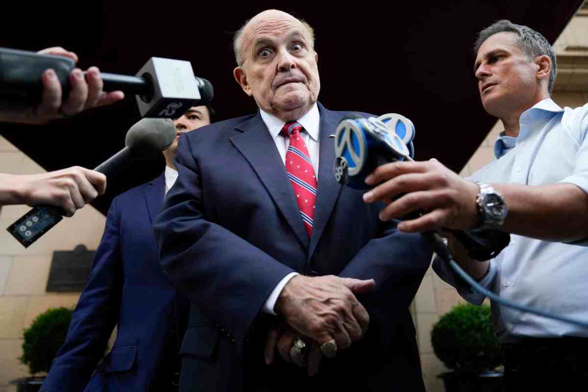 Former Mayor of New York Rudy Giuliani speaks to reporters as he leaves his apartment building in New York on Aug. 23, 2023. (AP Photo/Seth Wenig)