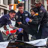 Emergency medical workers at scene with NYPD