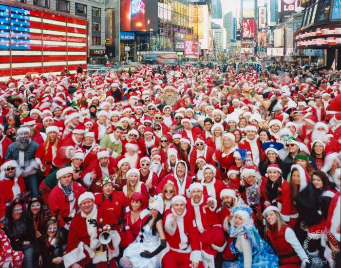 Large group of people in Santa Claus costumes at SantaCon