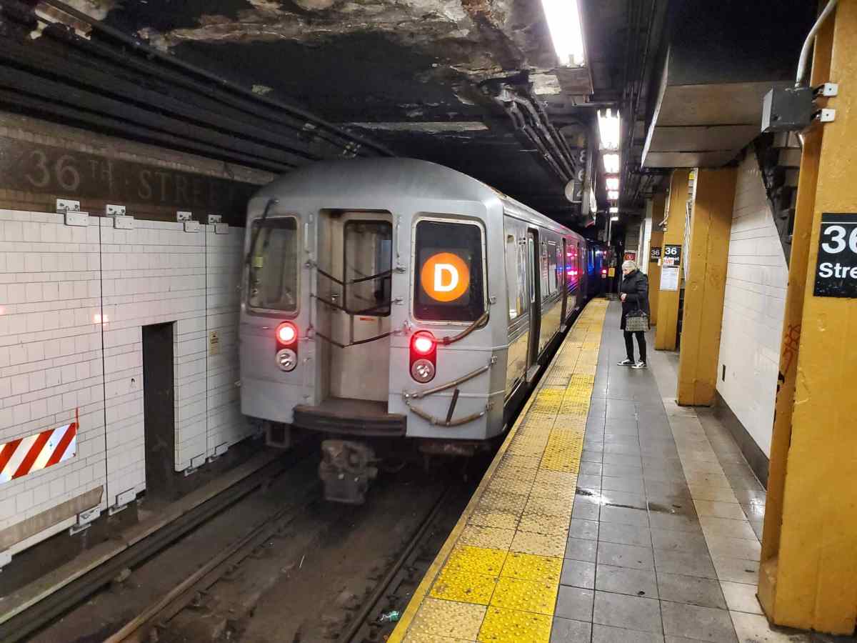 D subway train rolling into station