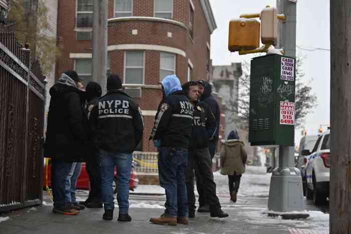 Police huddle after Brooklyn shooting