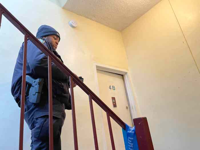 Police officer outside Brooklyn apartment where deadly shootings occurred