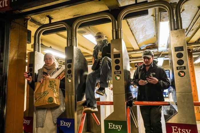 Fare evaders jumping the turnstile